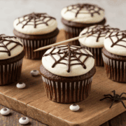 Chocolate cupcake with spiderweb decoration and white frosting, perfect for Halloween treats. Deliciously decorated for themed parties or spooky celebrations.